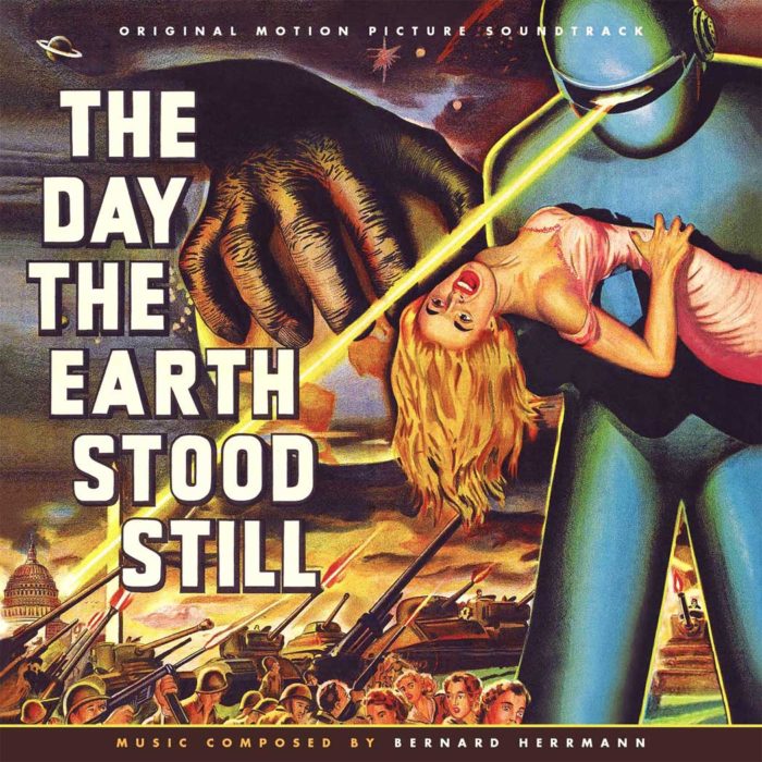 CD cover for the original motion picture soundtrack of "The Day the Earth Stood Still." The cover features a dramatic scene from the film with a giant alien holding a woman in its hand, while military tanks and soldiers surround them. The title "The Day the Earth Stood Still" is prominently displayed, along with the phrase "Music Composed by Bernard Herrmann."