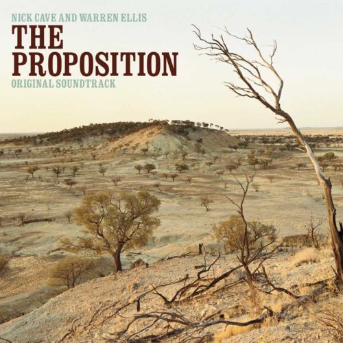 A barren, arid landscape with a lone, twisted tree stands out against a hazy sky. The title "The Proposition" is prominently displayed, along with the names Nick Cave and Warren Ellis as the composers. The image suggests a desolate and intense atmosphere, fitting for the film's western setting.