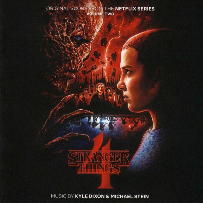 A vibrant, retro-inspired image featuring a cassette tape and a VHS tape against a dark background. The title "Stranger Things 2" is displayed prominently, along with the phrase "Original Score." The names of the composers, Kyle Dixon and Michael Stein, are included at the bottom. The overall aesthetic evokes the nostalgia of the 1980s, reflecting the show's setting.